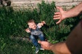 The young boy fell and pulled his hands up to his father`s hands Royalty Free Stock Photo