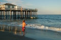 A young boy fishes in the ocean Royalty Free Stock Photo