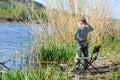 Young boy fishing on a lake shore Royalty Free Stock Photo