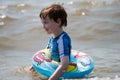 Young boy floating in inner tubes in a blissful state Royalty Free Stock Photo