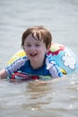 Young boy floating in inner tubes in a blissful state Royalty Free Stock Photo