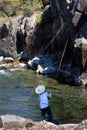 Young Boy Flyfishing in Rocky Alcove in Yellowstone National Park