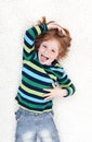 Young boy fooling around and playing on the floor