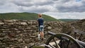 Young boy gazes out through the stone walls of a Rhine River Castle during a stormy day in Germany