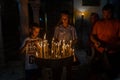 young boy and girl Christ pilgrims lightening up candles inside of Church of the Holy Sepulchre, Jerusalem, Israel