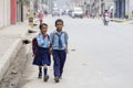 Young boy and girl going home from school after lessons at the local school in Kathmandu, Nepal