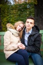 Young boy and girl hugging and kissing, sitting on the bench Royalty Free Stock Photo