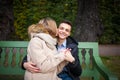 Young boy and girl hugging and kissing, sitting on the bench Royalty Free Stock Photo