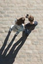 Young boy and girl look at mobile phone n the street. Royalty Free Stock Photo