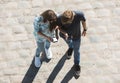 Young boy and girl look at mobile phone n the street. Royalty Free Stock Photo