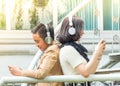 Young boy and girl play games and listen to music on mobile phones Royalty Free Stock Photo