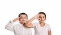 Young boy and girl salute while wearing face paint of their national flag, Indonesia
