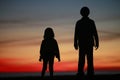 Young boy and girl in silhouet Royalty Free Stock Photo