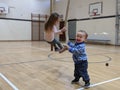 Young boy and girl swing on a climbing rope and laugh