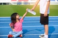 Young boy give a bottle of water to young girl