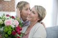 Young boy giving flowers to his mother Royalty Free Stock Photo