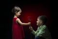 Young boy giving a rose to a little girl Royalty Free Stock Photo