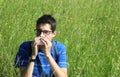 Young boy with glasses blowing his nose because of allergy in th Royalty Free Stock Photo