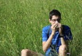 Young boy with glasses blowing his nose because of allergy in th Royalty Free Stock Photo