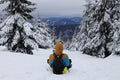 Young boy goes down hill on a plastic shovel. Adolescent go downhill on butt. Stupid things in mountains. Enjoying a new snow. Man