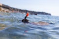 Young boy in goggles and pipe diving in sea Royalty Free Stock Photo