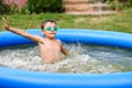 Young boy with goggles in swimming pool