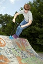 Young boy going airborne with a scooter Royalty Free Stock Photo