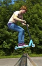 Young boy going airborne with a scooter Royalty Free Stock Photo