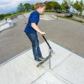 Young boy going airborne with scooter Royalty Free Stock Photo