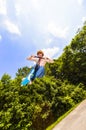 Young boy going airborne with a scooter Royalty Free Stock Photo