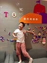 Young boy happily pointing to the LEGO brocks on the wall