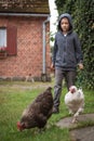 Young boy hases hens Royalty Free Stock Photo