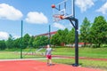 Young boy having fun playing basketball outdoors.nice,cool caucasian alone player playing basketball outdoors