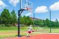 Young boy having fun playing basketball outdoors.nice,cool caucasian alone player playing basketball outdoors