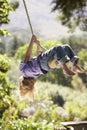 Young Boy Having Fun On Rope Swing