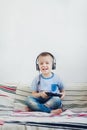 Young boy in headphone playing with playstation at home