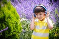 Young boy in headphones listening to modern music in nature. Child likes the song. Kid music relax concept after school classes