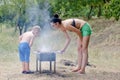 Young boy helping at the barbecue