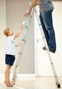 He loves assisting dad. Young boy helping his father with changing a lightbulb. Royalty Free Stock Photo