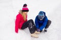 Young boy helps to the girl ties bootlaces up skates Royalty Free Stock Photo