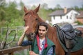 Young boy during the high mounting walking meets a young horse and communicates with it, wild nature, people and animals