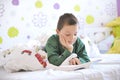 Young boy in his bed reading a book Royalty Free Stock Photo