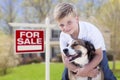 Young Boy and His Dog in Front of For Sale Sign and House Royalty Free Stock Photo