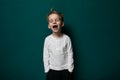 Young Boy Standing in Front of Green Wall Royalty Free Stock Photo