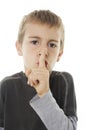 Young boy with his finger over his mouth Royalty Free Stock Photo