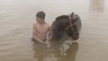 Young boy and his horse in thermal water, Guroymak, Bitlis Royalty Free Stock Photo