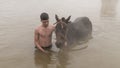 Young boy and his horse in thermal water, Guroymak, Bitlis Royalty Free Stock Photo