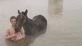 Young boy and his horse in thermal water, Guroymak, Bitlis Royalty Free Stock Photo