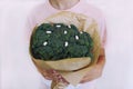 Young boy holding broccoli in hands. Concept healthy food Royalty Free Stock Photo