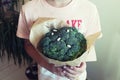 Young boy holding broccoli in hands. Concept healthy food Royalty Free Stock Photo